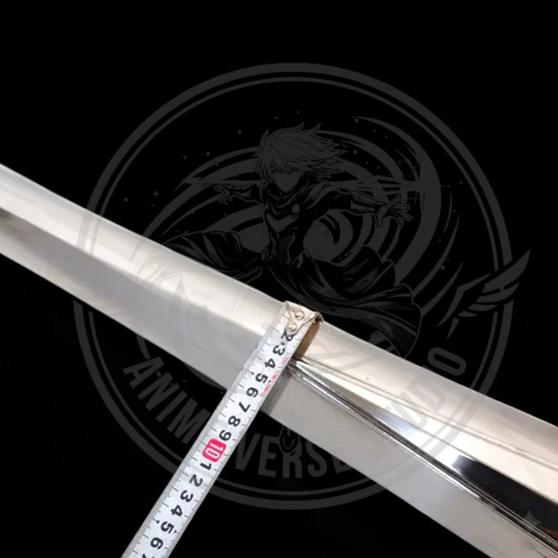 May include: A polished, silver-colored sword blade with a tape measure showing a measurement. The blade is set against a black background with a circular logo that reads "Anime Universe". The blade appears to be approximately 4 inches long.