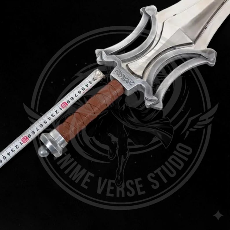 May include: A silver-colored sword with a brown leather-wrapped handle. The blade is shiny and the hilt has an ornate design. A measuring tape is placed along the handle, showing measurements in inches. The sword is likely a prop or collectible.