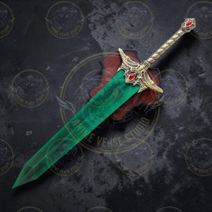 May include: A decorative sword with a green blade and gold hilt, adorned with red gemstones. The hilt features intricate designs and a twisted grip. The sword is displayed on a wooden plaque, with the text "ANIME VERSE STUDIO" visible.