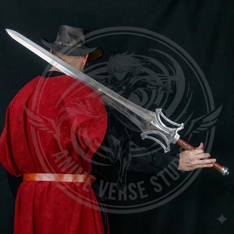 May include: A large, silver sword with a wide blade and ornate hilt. The handle is wrapped in brown leather. The person in the image is wearing a red robe and a black hat. The sword is held in front of the person.