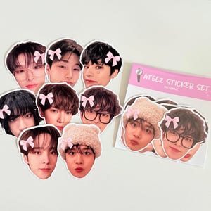 May include: A collection of die-cut stickers featuring images of people with pink bows and a beige hat. The stickers are arranged on a white surface, with a pink and white card that reads "ATEEZ STICKER SET".