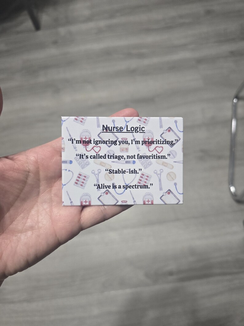 May include: A small, rectangular card with the text "Nurse Logic" and several quotes related to nursing. The card has a white background with medical-themed illustrations and is held in a hand.