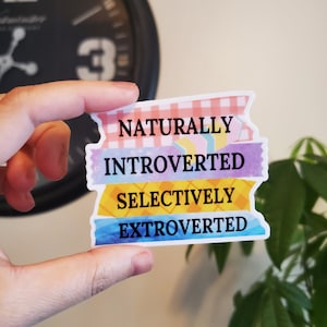 May include: A sticker with the text "Naturally Introverted Selectively Extroverted" on a white background with colorful patterned stripes.