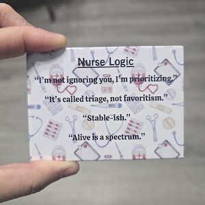 May include: A rectangular card with the text "Nurse Logic" and medical-themed illustrations. The card features humorous quotes such as "I'm not ignoring you, I'm prioritizing" and "Alive is a spectrum."