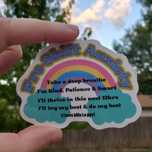 May include: A sticker with a rainbow and the text "Pre-Shift Anxiety" in a retro font. The text below the rainbow reads "Take a deep breathe I'm Kind, Patience & Smart I'll thrive in this next 12hrs I'll try my best & do my best (I have bills to pay)"