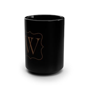 May include: Black ceramic mug with a brown monogram "W" in a decorative frame.
