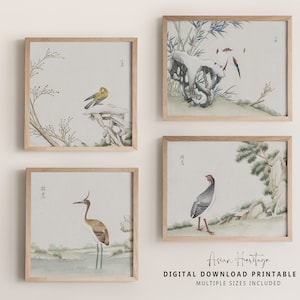 May include: Set of four printable art prints featuring Asian-inspired illustrations of birds and foliage. The prints are in a minimalist style with muted colors and delicate details. The prints are framed in a light wood frame.