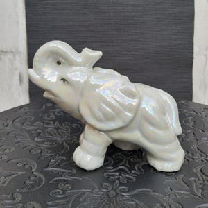 Retro white porcelain baby elephant figurine.