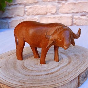 Wooden buffalo.Vintage wooden figure. Carved wood. Sculpture of a buffalo.