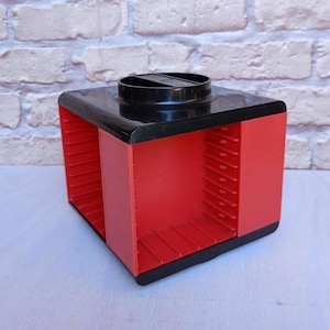 Vintage plastic audio cassette holder. Retro carousel. Rotating cassette box. Stand for audio cassettes. Old rack from the 70s.