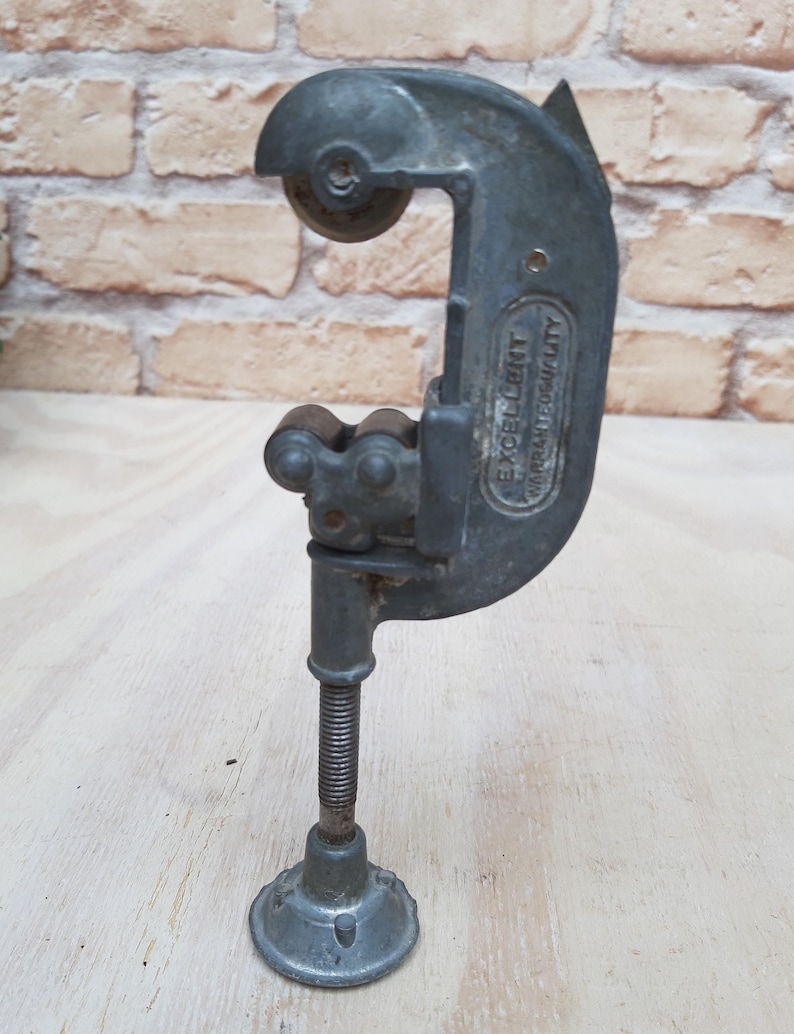 May include: A silver pipe cutter with a black handle and a screw adjustment. The cutter is labeled "EXCELLENT QUALITY".