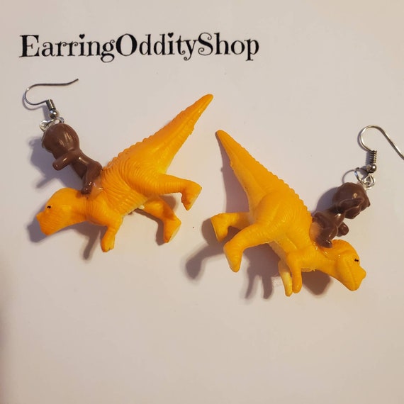 Babies riding dinosaur earrings