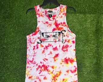 May include: White tank top with a tie-dye pattern in red and yellow. The tank top has a black and white graphic of a character's eyes with the text "Cosmos Designs" at the bottom.