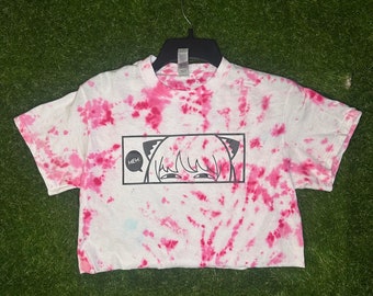 May include: White cropped t-shirt with a pink tie-dye pattern. The shirt features a black and white graphic of an anime character with the text "HEH!" in a speech bubble.