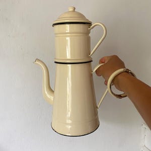 Antique coffee pot in enamelled sheet metal,