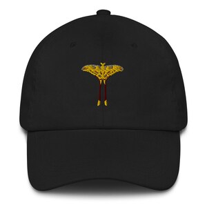 May include: A black baseball cap with an embroidered yellow and red moth design.