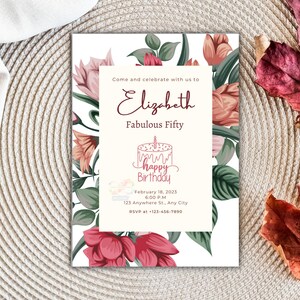 May include: A birthday invitation with floral elements and the text "Elizabeth Fabulous Fifty." The invitation includes a cake illustration and the words "Happy Birthday." The design features pink and red flowers and green leaves.