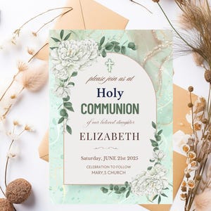 May include: A Holy Communion invitation with a floral design. The invitation features the text "Holy Communion" and the name "Elizabeth". The date is Saturday, June 21st, 2025. The design includes white flowers and green foliage.