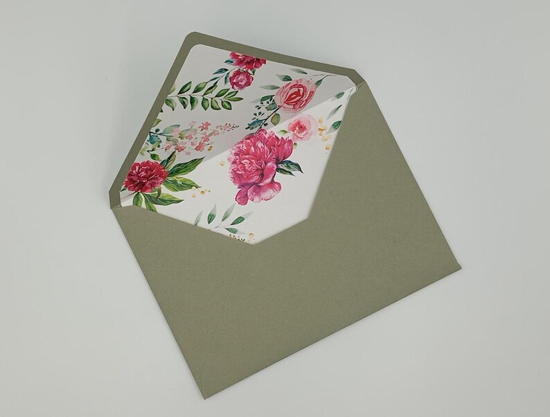 May include: A green envelope with a floral pattern on the inside flap. The pattern features pink and red flowers with green leaves on a white background.