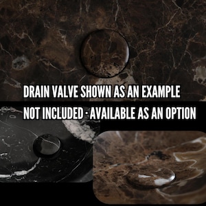 May include: Close-up of a dark brown marble surface with a circular drain valve. The text reads "DRAIN VALVE SHOWN AS AN EXAMPLE NOT INCLUDED - AVAILABLE AS AN OPTION". The drain valve is a dark brown color and appears to be made of stone.