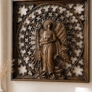 May include: A wooden wall art piece featuring a carved angel figure within a decorative frame. The angel holds a chalice and staff, set against a detailed, openwork background. The artwork is finished in a warm brown tone.