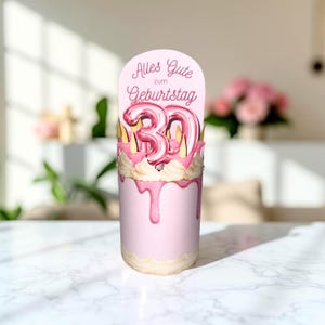 May include: A pink birthday cake with a pink and white frosting design. The cake has a pink drip effect and is topped with a pink balloon number 30. The cake also has a sign that says "Alles Gute zum Geburtstag".