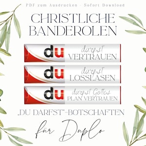 May include: Three rectangular paper wrappers for chocolate bars featuring the text du darfst followed by the words VERTRAUEN, LOSLASEN, and GOTTES PLAN VERTRAUEN. The design includes red and white accents with olive branch illustrations.