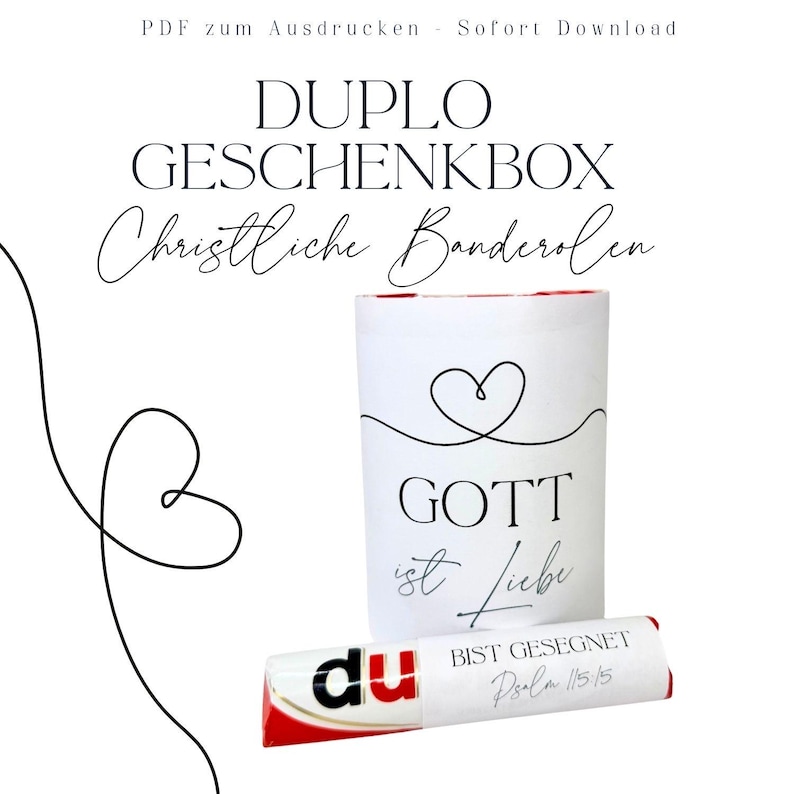 May include: A white gift box with a heart design and the words "GOTT ist Liebe" printed on it. A wrapped chocolate bar with the word "du" and the text "BIST GESEGNET Psalm 115:15" is in front of the box. The image also includes the text "DUPLO GESCHENKBOX Christliche Banderolen".