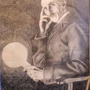 May include: A framed charcoal portrait of a man in a suit, holding a lightbulb. The man has a mustache and is resting his head on his hand. The background is dark, and the image is in a black frame.