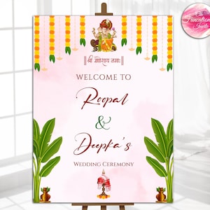 Può includere: Un cartello di benvenuto per una cerimonia nuziale con i nomi "Roopal & Deepika's" in una scrittura decorativa. Il cartello include una raffigurazione di Ganesha, ghirlande floreali e altri elementi decorativi, su uno sfondo rosa tenue.