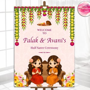 May include: A decorative sign for a Half Saree Ceremony. The sign features the text "Welcome to Palak & Avani's" in a burgundy script. Two cartoon figures in traditional attire are seated on a sofa. Floral and leaf garlands adorn the top.