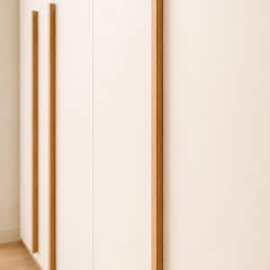 May include: A close-up of a white cabinet with vertical wooden accents. The wooden accents are rectangular and run the length of the cabinet doors. The wood has a natural, light brown color. The cabinet is in a room with a light-colored wooden floor.