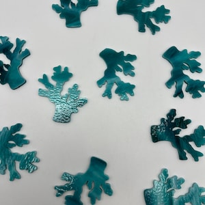 May include: Ten teal blue glass coral pieces in various shapes and sizes. The coral pieces are all hand-crafted and have a unique, textured surface.