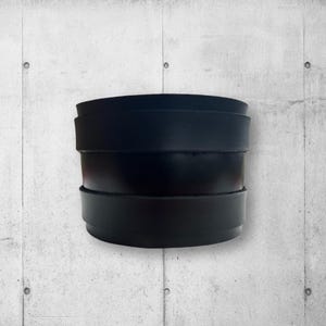 May include: A black leather bracelet with multiple layers.