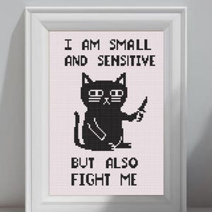 May include: Cross-stitch pattern featuring a black cat meme with the text "I AM SMALL AND SENSITIVE BUT ALSO FIGHT ME." The design is framed in a white border, with the text "Funny Cat Meme Cross Stitch Pattern" at the top and "PDF Digital Download color pattern" at the bottom.