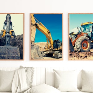 May include: Three framed photographs of yellow construction equipment. The first photo shows a close-up of a yellow excavator's arm and bucket. The second photo shows a yellow excavator digging in a dirt pit. The third photo shows a yellow bulldozer with its front blade raised.