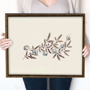 May include: A framed print of a watercolor illustration of a branch with blue bells. The branch is brown and the bells are a light blue color. The print is 16x20 inches.