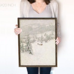 May include: A framed painting depicting a snowy winter scene with a group of people travelling by sled. The painting is in a brown frame and measures 16x20 inches.