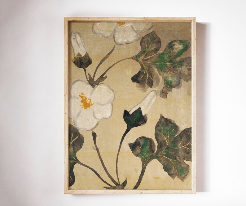 May include: A framed painting of white flowers with green leaves on a beige background. The flowers are stylized and have a yellow center. The leaves are a dark green with hints of gold.