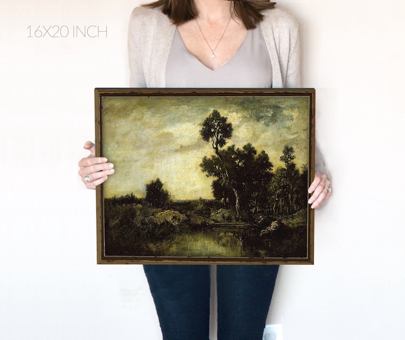 May include: A framed landscape painting depicting a river scene with trees and a cloudy sky. The painting is in a dark brown frame and is 16x20 inches.