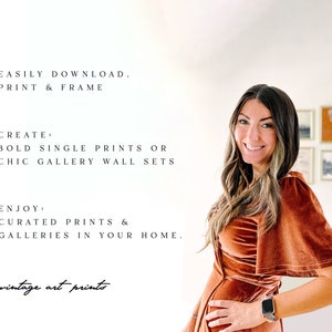 May include: A woman in a rust-colored velvet dress stands in front of a white wall with a gallery wall of framed prints behind her. The text on the wall reads "EASILY DOWNLOAD. PRINT & FRAME", "CREATE: BOLD SINGLE PRINTS OR CHIC GALLERY WALL SETS", "ENJOY: CURATED PRINTS & GALLERIES IN YOUR HOME." and "vintage art prints".