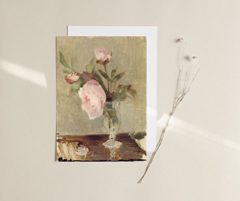 May include: A painting of a bouquet of pink peonies in a glass vase on a wooden table.