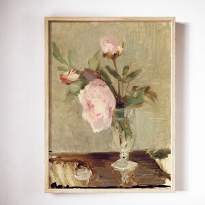 May include: A painting of a bouquet of pink peonies in a clear glass vase on a wooden table. The background is a muted green.