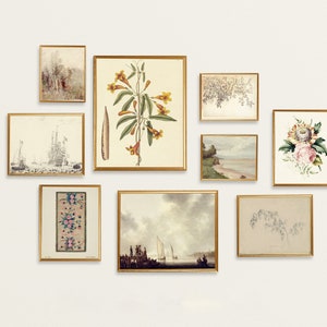 May include: A gallery wall with nine framed prints featuring botanical illustrations, seascapes, and abstract designs. The prints are in gold frames and arranged in a symmetrical pattern on a white wall.