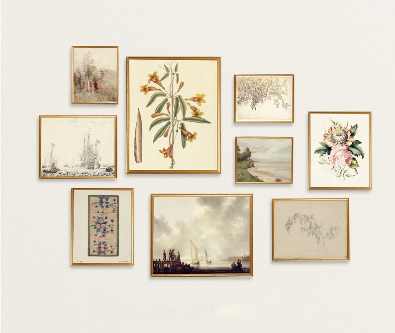 May include: A gallery wall with nine framed prints featuring botanical illustrations, seascapes, and abstract designs. The prints are in gold frames and arranged in a symmetrical pattern on a white wall.