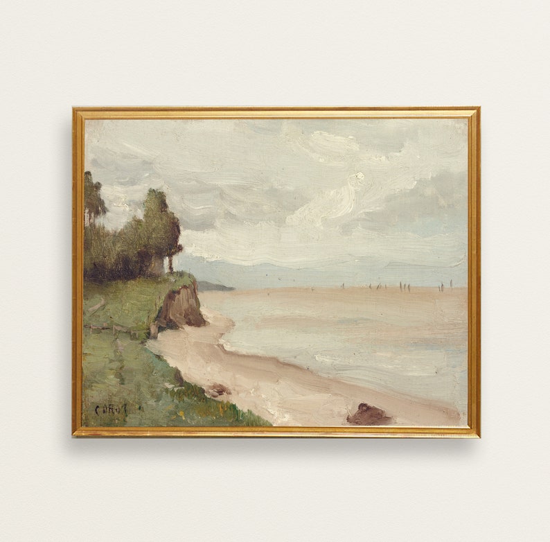May include: A framed painting depicting a seascape with a sandy beach, a rocky cliff, and a line of trees in the foreground. The sky is cloudy and the water is calm. The painting is in a gold frame.