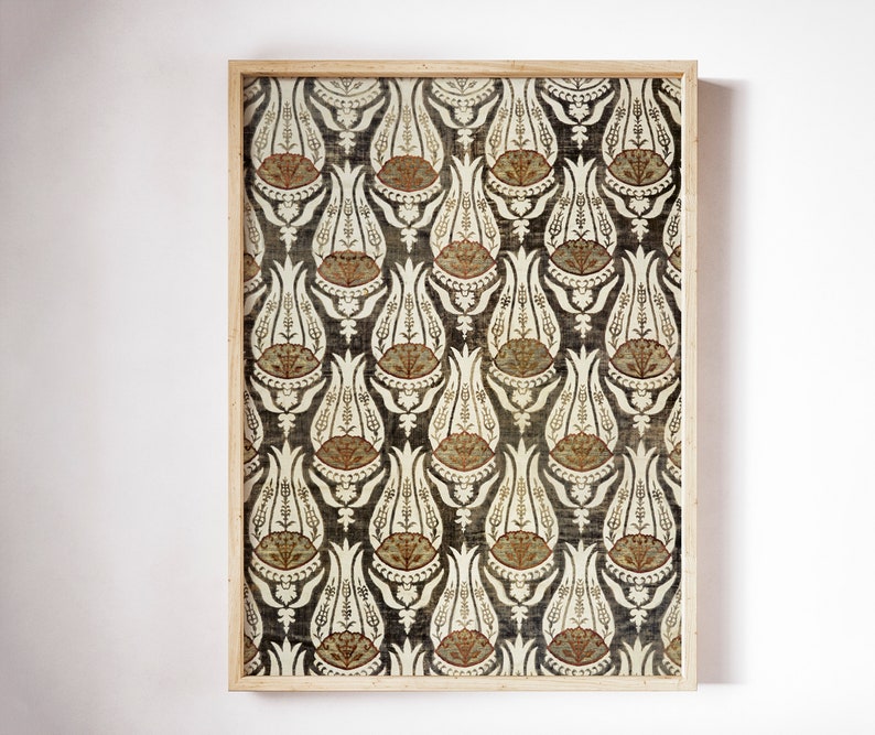 May include: A framed print of a vintage fabric with a repeating pattern of stylized white tulips on a dark gray background. The tulips have brown and orange accents.