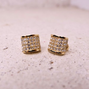 Christian Dior vintage clip-on earrings in gold-tone metal and white rhinestones