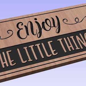 May include: Wooden sign with a black banner that reads "Enjoy the little things" with a decorative flourish above the text.