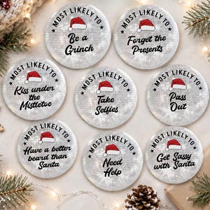 May include: Eight circular buttons with a silver disco ball pattern, each featuring a red Santa hat icon and the text Most Likely To followed by phrases including Be a Grinch, Forget the Presents, Kiss under the Mistletoe, Take Selfies, Pass Out, Have a better beard than Santa, Need Help, and Get Sassy with Santa.